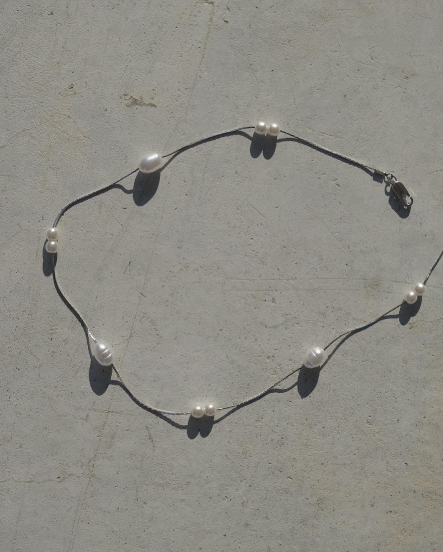 Line Crossed Pearl Necklace